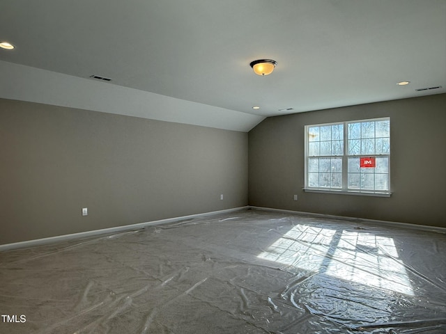 bonus room with lofted ceiling, visible vents, and baseboards