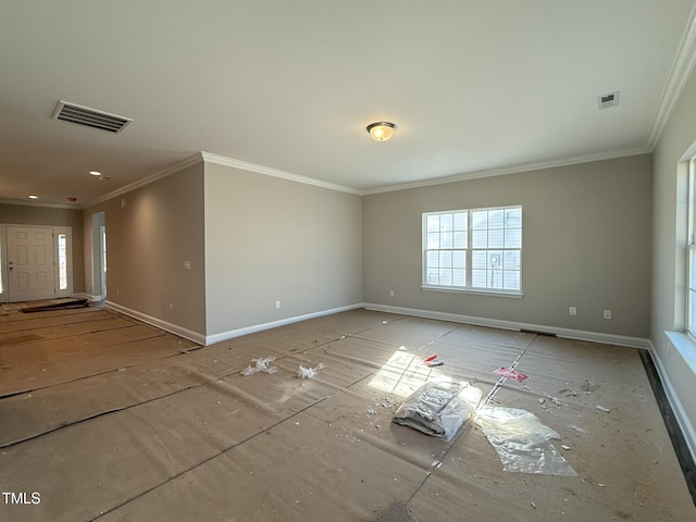 empty room featuring ornamental molding, visible vents, and baseboards