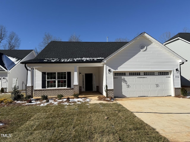 view of front of property featuring a garage, a front yard, concrete driveway, and brick siding