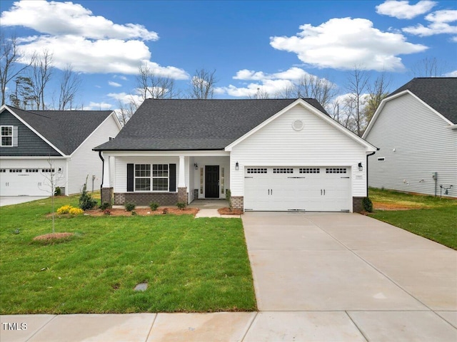 1985 Meadowview Dr, Graham, NC 27253 - view of front facade featuring driveway, an attached garage, brick siding, a front lawn, and a shingled roof