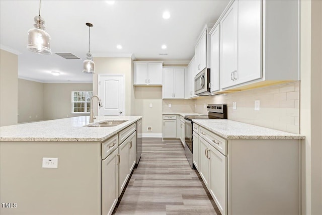 1985 Meadowview Dr, Graham, NC 27253 - kitchen with light wood finished floors, ornamental molding, stainless steel appliances, tasteful backsplash, and a sink
