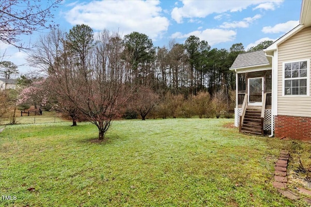 view of yard with stairway and a sunroom