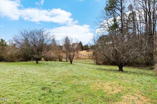 view of yard featuring a rural view and fence