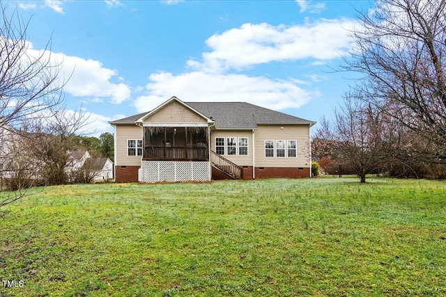 back of house featuring a lawn, crawl space, stairs, and a sunroom