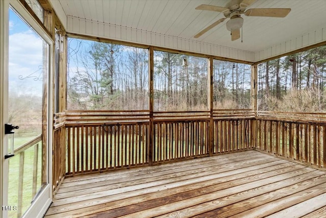 unfurnished sunroom featuring a ceiling fan