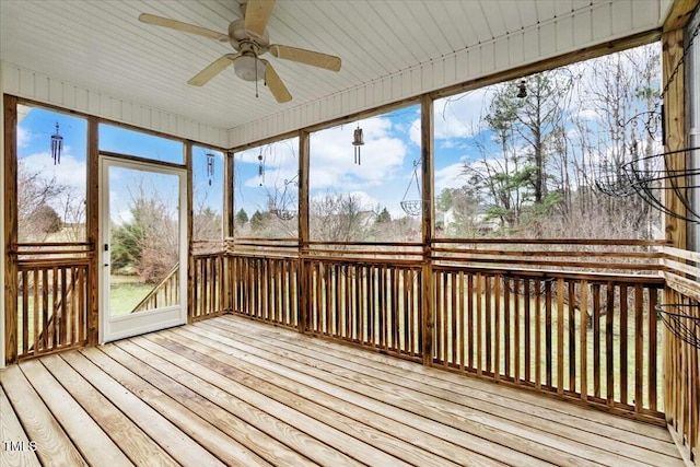 unfurnished sunroom with ceiling fan