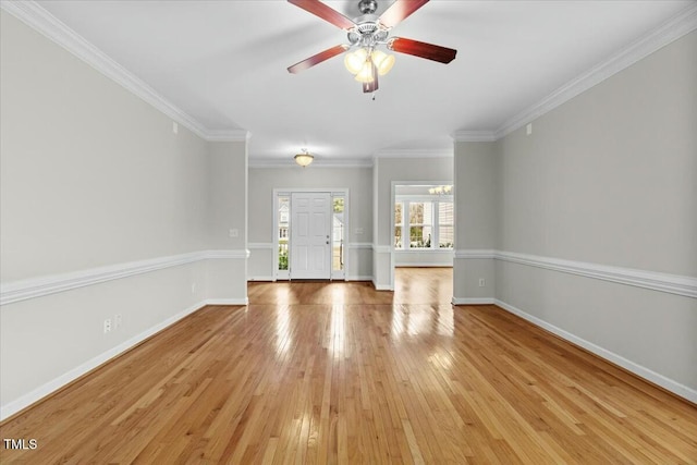 unfurnished living room featuring light wood finished floors, ceiling fan, baseboards, and ornamental molding