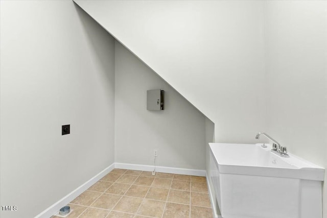 clothes washing area with laundry area, electric dryer hookup, baseboards, and light tile patterned floors