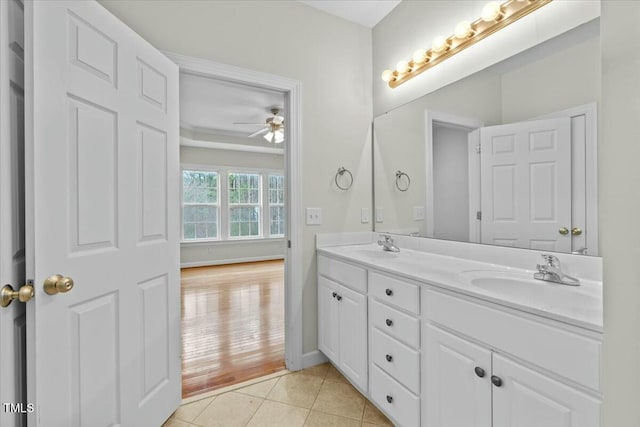 full bath with a ceiling fan, double vanity, a sink, and tile patterned floors