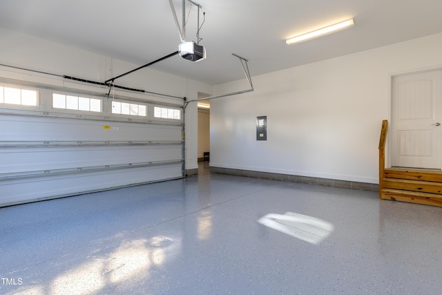 garage with electric panel and a garage door opener