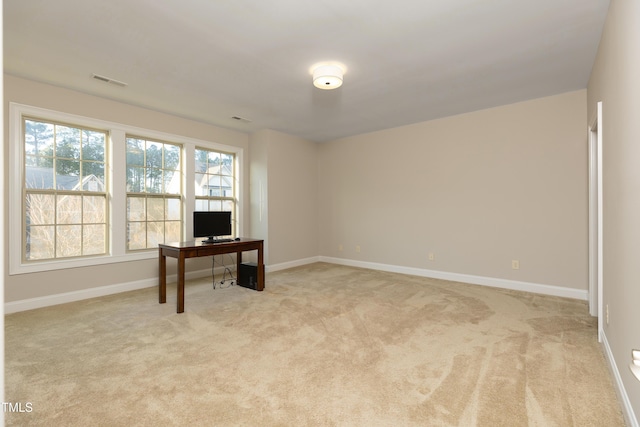 office featuring light colored carpet, visible vents, and baseboards