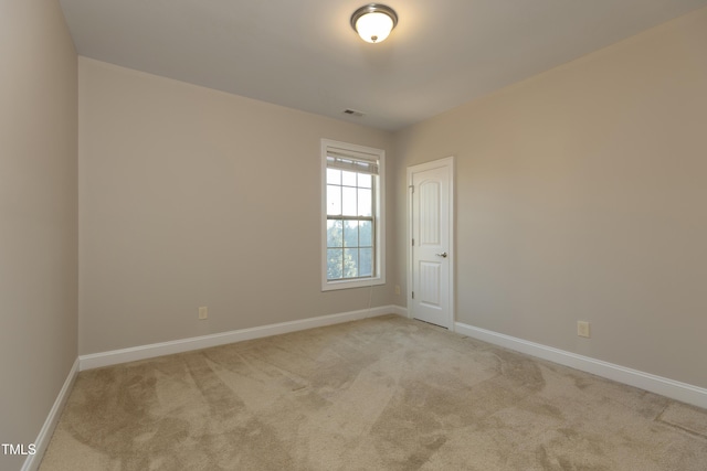 carpeted spare room with baseboards