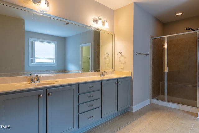 full bathroom with a sink, a stall shower, double vanity, and tile patterned floors