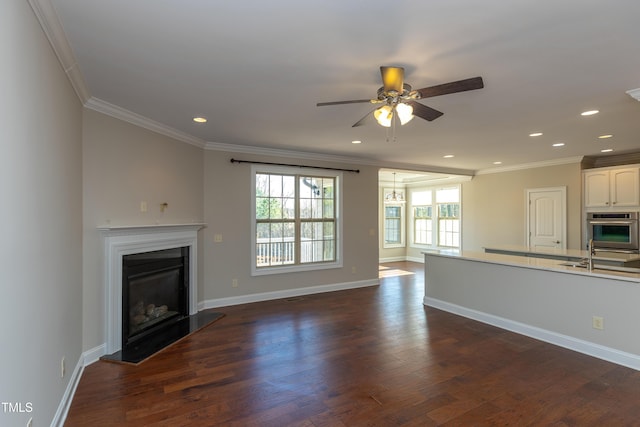 unfurnished living room featuring a glass covered fireplace, crown molding, and dark wood-style floors