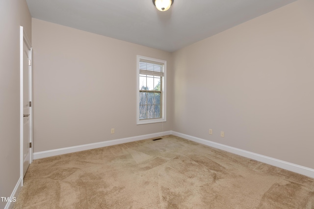 unfurnished room featuring visible vents, carpet, and baseboards