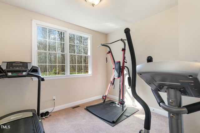 workout area with baseboards, visible vents, and light colored carpet