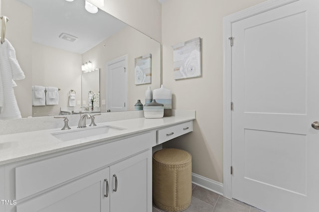 bathroom with tile patterned floors, visible vents, baseboards, and vanity