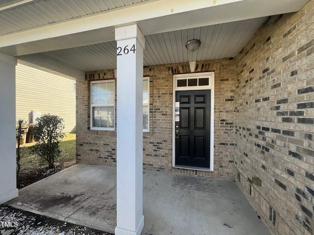 entrance to property with brick siding