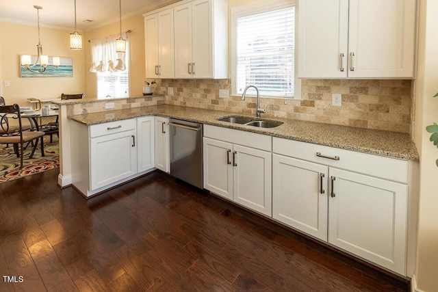 kitchen with dark wood finished floors, a peninsula, a sink, stainless steel dishwasher, and crown molding