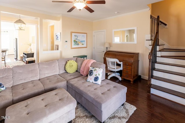 living area featuring a ceiling fan, wood finished floors, stairs, and crown molding