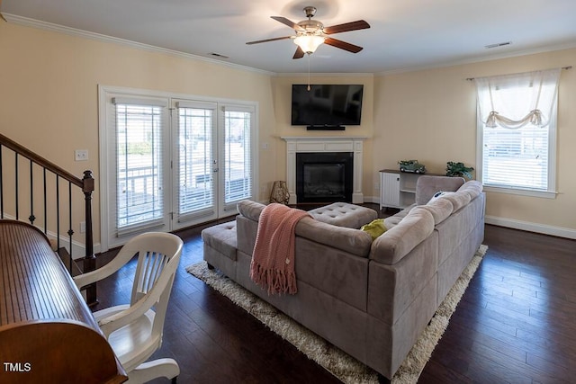 living room featuring visible vents, plenty of natural light, and ornamental molding