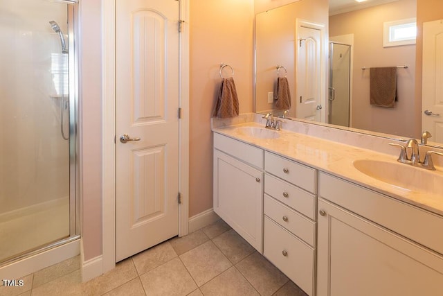 full bath featuring tile patterned flooring, a stall shower, double vanity, and a sink