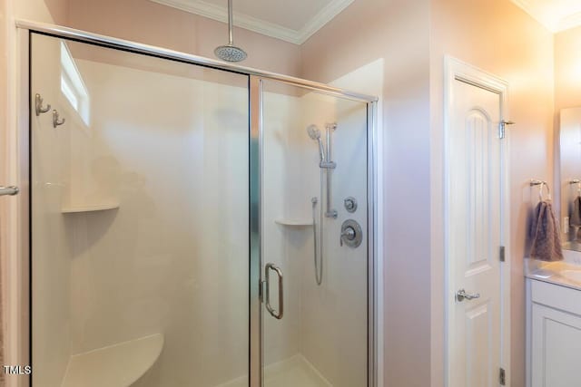 bathroom featuring a stall shower, vanity, and crown molding