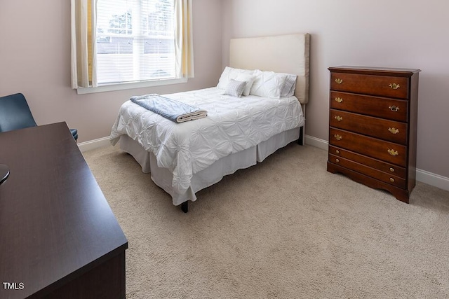 bedroom with baseboards and carpet