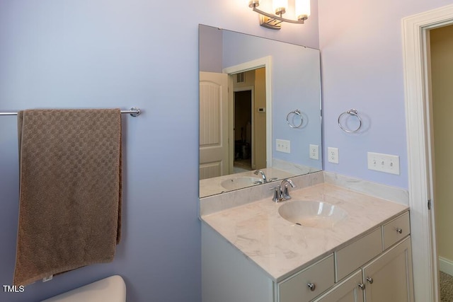 bathroom with toilet and vanity