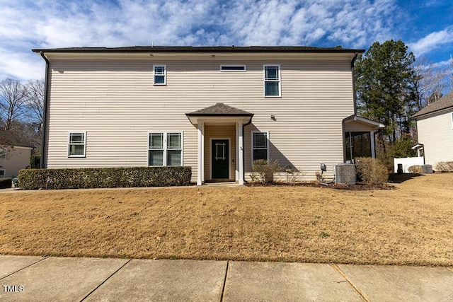 exterior space featuring central AC and a front lawn