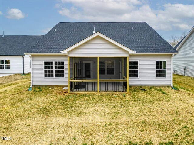 1987 Meadowview Dr, Graham, NC 27253 - back of property with a shingled roof, a sunroom, and a yard