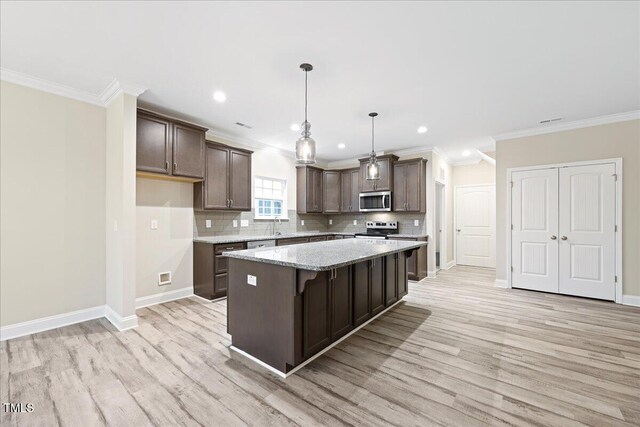 1987 Meadowview Dr, Graham, NC 27253 - kitchen with a center island, dark brown cabinetry, decorative backsplash, and appliances with stainless steel finishes
