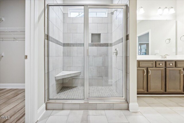 1987 Meadowview Dr, Graham, NC 27253 - bathroom featuring a shower stall, a walk in closet, tile patterned flooring, and vanity