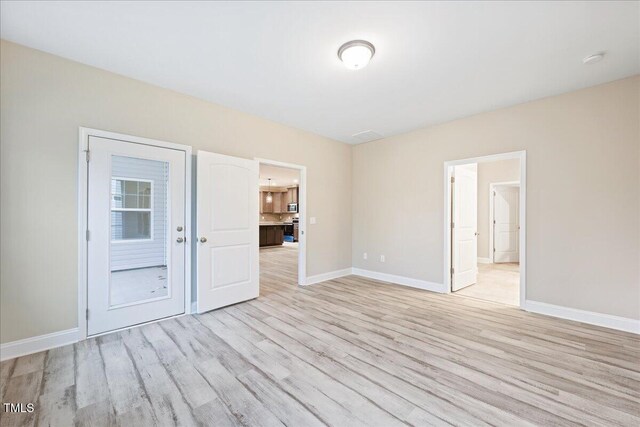 1987 Meadowview Dr, Graham, NC 27253 - unfurnished room featuring baseboards and light wood-style floors