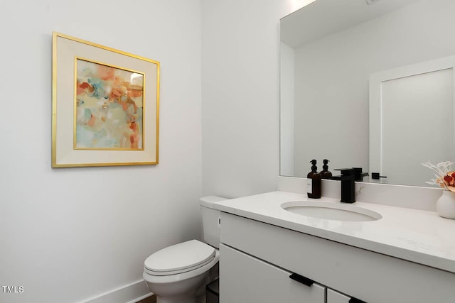 bathroom featuring toilet and vanity