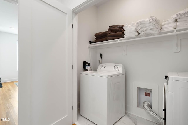 laundry area with marble finish floor, washing machine and dryer, and laundry area