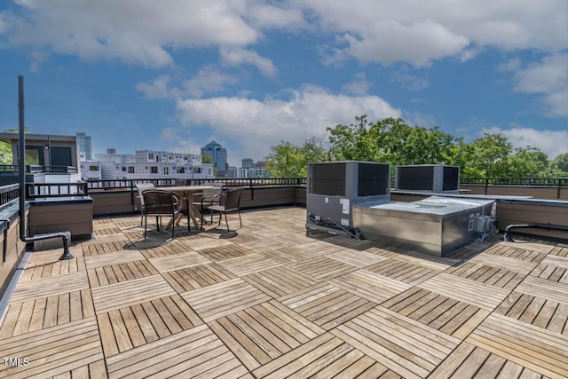 wooden terrace featuring a city view