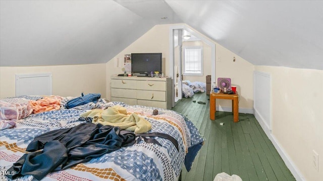 bedroom featuring vaulted ceiling, wood finished floors, and baseboards