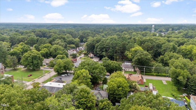 birds eye view of property featuring a wooded view and a residential view