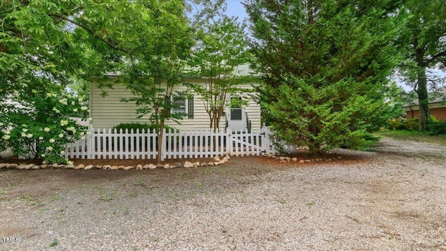 obstructed view of property featuring a fenced front yard