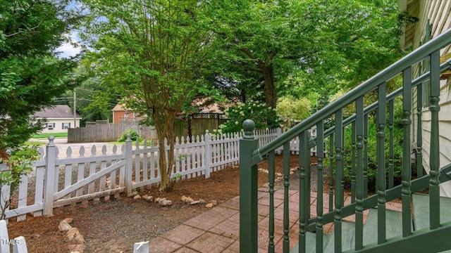 exterior space with a fenced front yard and a gate