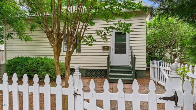 exterior space featuring entry steps and fence