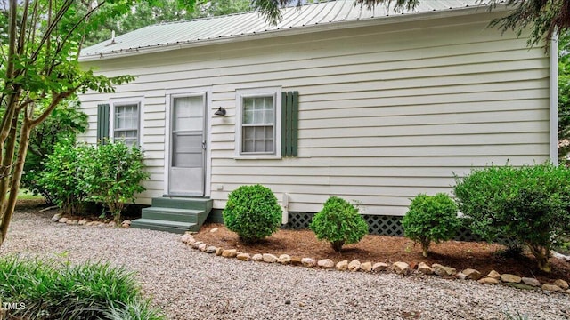 doorway to property with metal roof