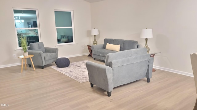 living room featuring light wood-type flooring and baseboards