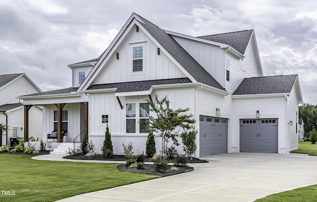 modern farmhouse style home featuring concrete driveway, a front lawn, board and batten siding, and a shingled roof