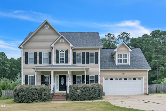 colonial inspired home with a shingled roof, a porch, a garage, driveway, and a front lawn