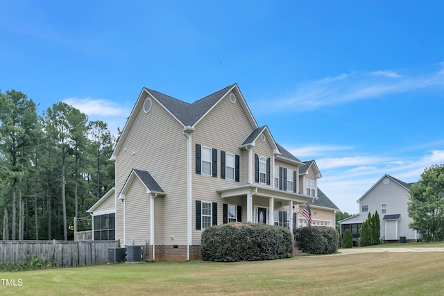 view of front of house featuring a front yard, crawl space, fence, and central AC unit