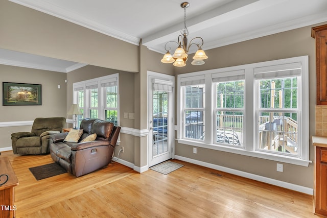 interior space featuring light wood finished floors, ornamental molding, and baseboards