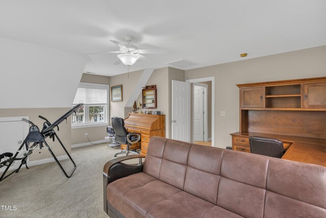 living area with a ceiling fan, light colored carpet, and baseboards