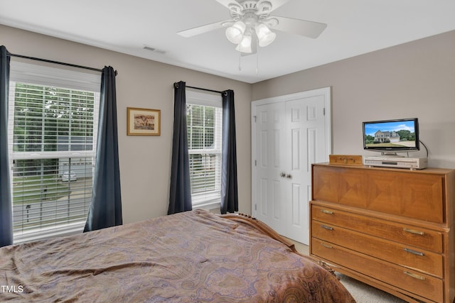 bedroom with ceiling fan, a closet, and visible vents